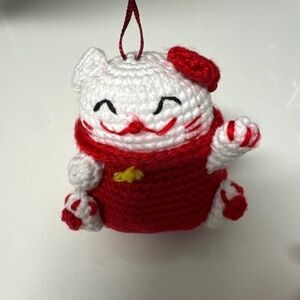 handmade crochet amigurumi Maneki Neko, also known as a Japanese lucky cat